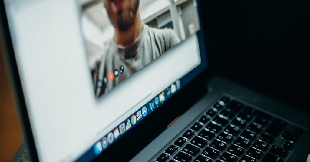Close-up of a person engaged in a video call on a laptop indoors, showcasing modern technology.